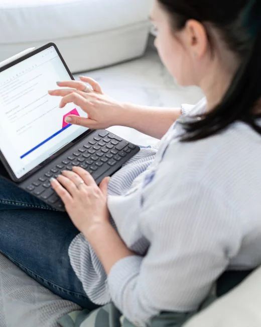 A varied team working together on digital marketing strategies at a desk, using laptops and tablets.